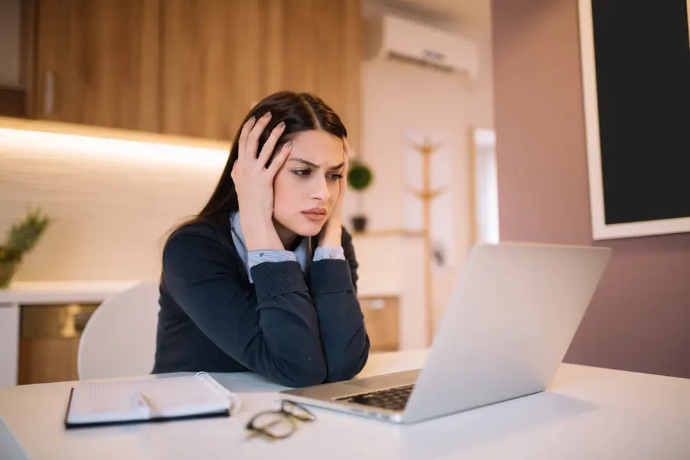 woman concerned looking at laptop